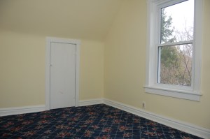 The flooring in the back bedroom when we moved in.